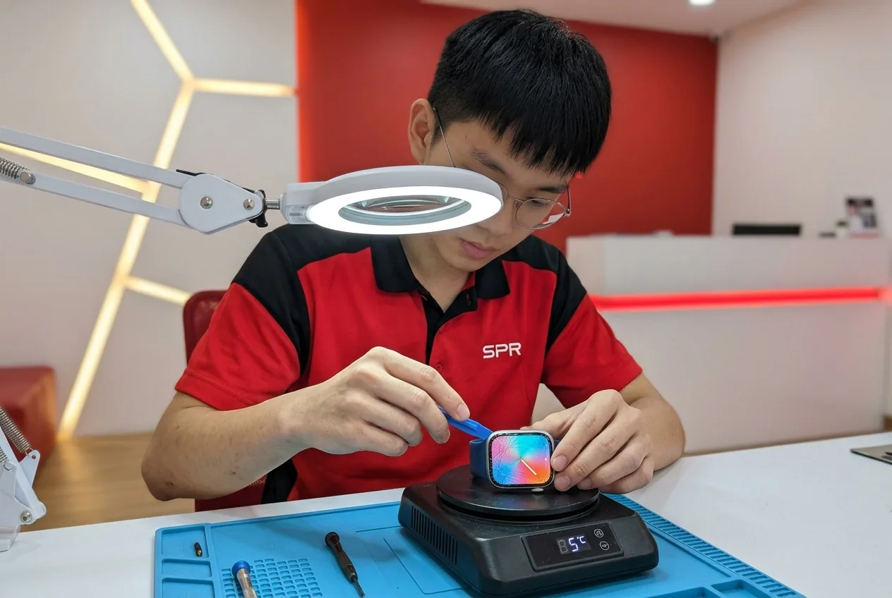 Apple Watch with a cracked front glass being checked before a glass replacement